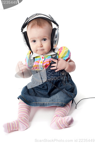 Image of Little cute baby girl in headphones