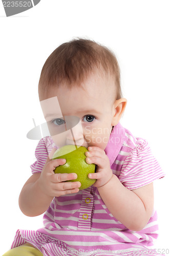 Image of Baby girl in pink eating apple
