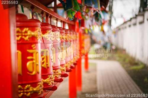 Image of Line of red praying drums at datsan