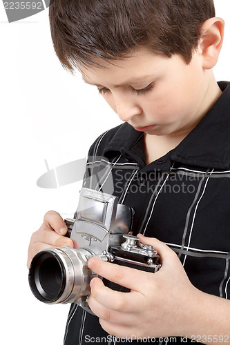 Image of young boy with old vintage analog SLR camera