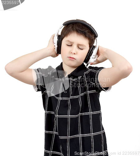 Image of Portrait of a happy young boy listening to music on headphones