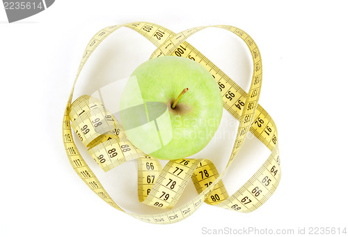 Image of Green apple and measuring tape isolated on white background
