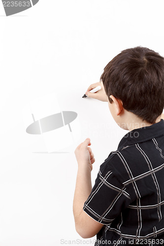 Image of young boy student in a writing on a whiteboard