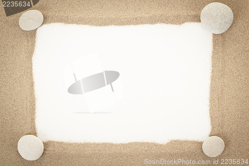 Image of stones with sand and white paper as background 