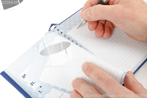 Image of Close-up of hand beginning to write on notes