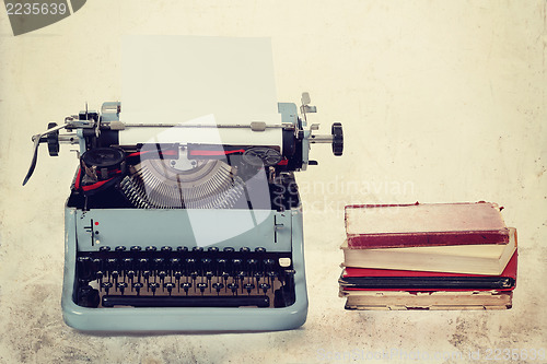 Image of Old typewriter with books retro colors on the desk