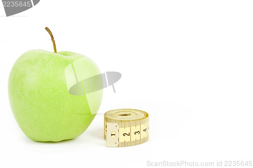 Image of Green apple and measuring tape isolated on white background