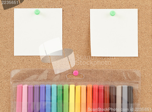 Image of color markers with notes on cork board 
