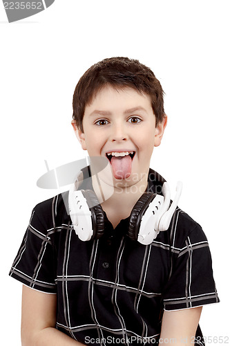 Image of Young boy grinning and show tongue with headphones