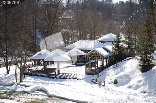 Image of frozen river bay water wooden house bank roof snow 