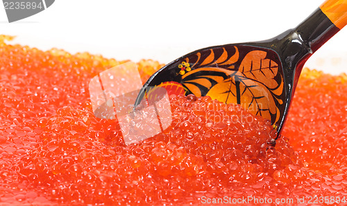 Image of Red salted caviar with wooden spoon