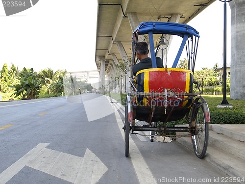 Image of Trishaw under a bridge