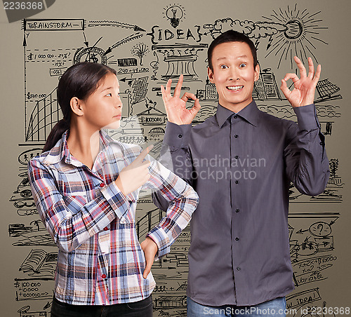 Image of Asian Man and Girl Showing OK