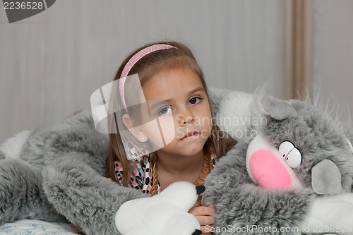 Image of Girl with cat soft toy