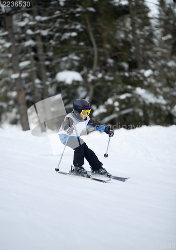 Image of Little skier doing slalom 