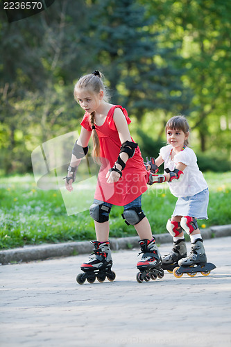 Image of Sisters skating in park