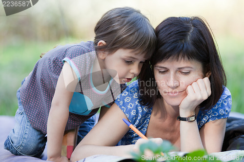 Image of Mother and daughter playing outdoors