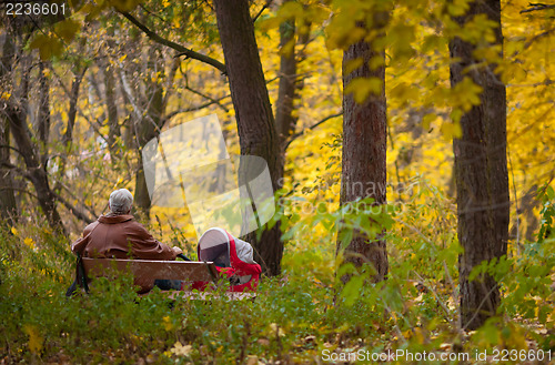 Image of Grandpa with trolley in the Autumn park