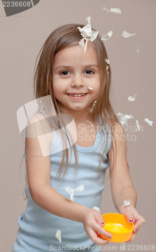 Image of Girl playing with paper