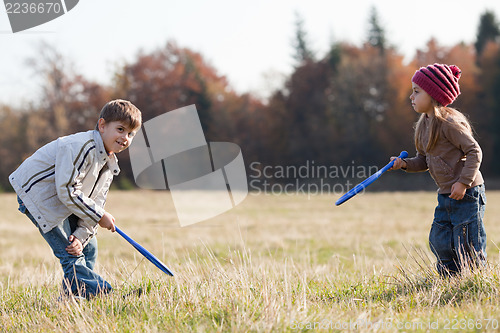 Image of Kids playing tennis outside