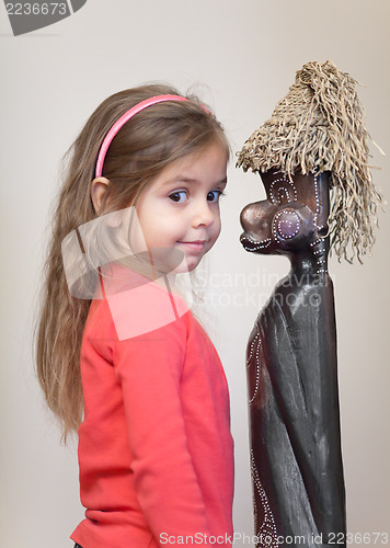 Image of Little girl with ethnic doll