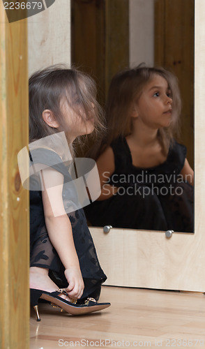 Image of Little girl reflected in mirror