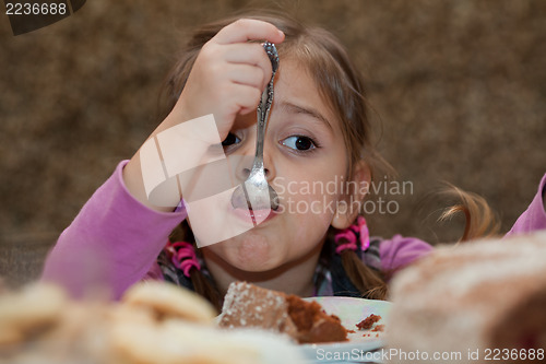 Image of Little girl eating cake