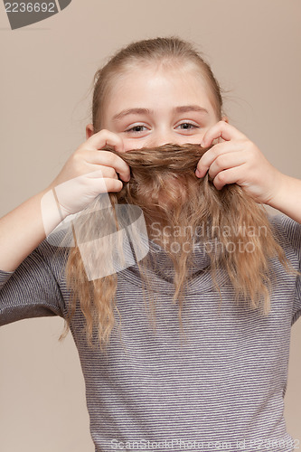 Image of Little girl making  moustache