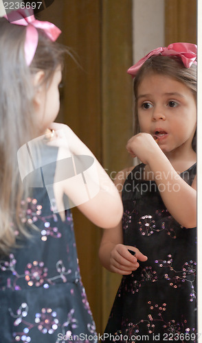 Image of Portrait of little girl reflected in mirror