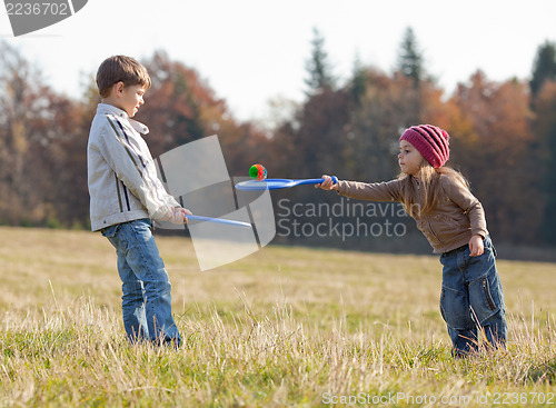 Image of Kids playing tennis outside