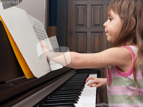 Image of Little girl playing the piano