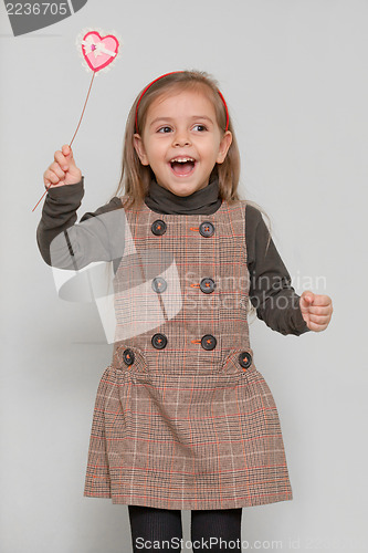 Image of Cute little girl holding  heart shape