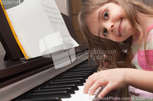 Image of Little girl playing piano