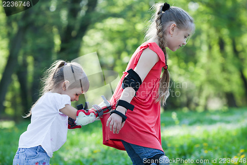 Image of Sisters skating in park