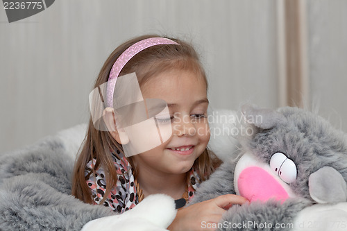 Image of Girl with cat soft toy