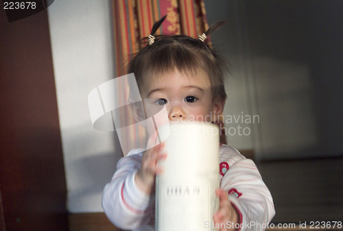 Image of Anael playing with a round box