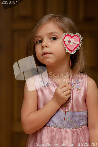 Image of Cute little girl holding up a heart shape