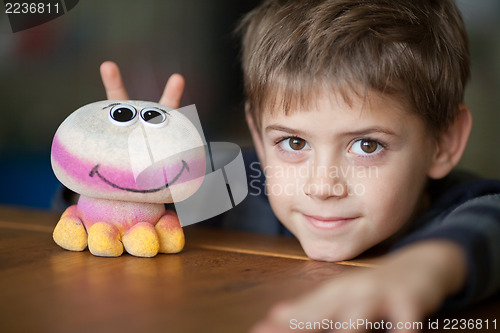 Image of Smiling Boy and Alien Toy  with Antennas