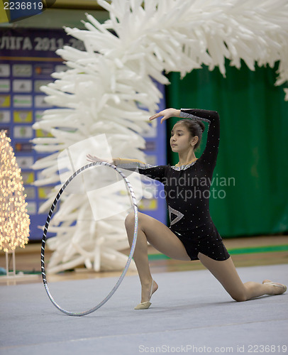 Image of Gymnast girl doing exercise with hoola hoop