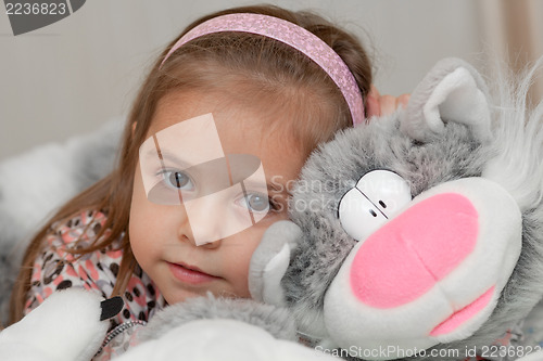 Image of Girl with cat soft toy