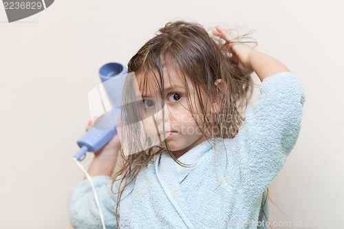 Image of Little girl drying her hair