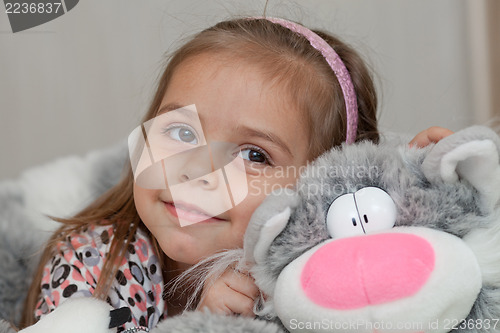 Image of Girl with cat soft toy