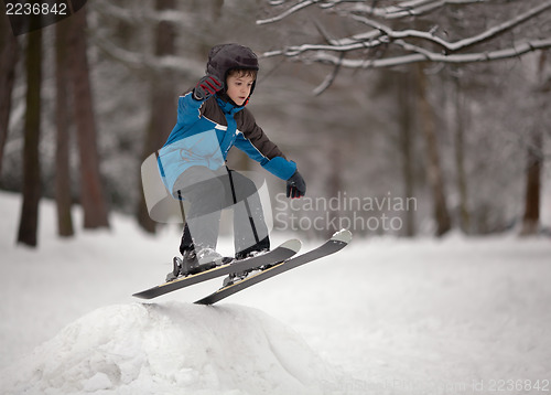 Image of Little boy skier jumping