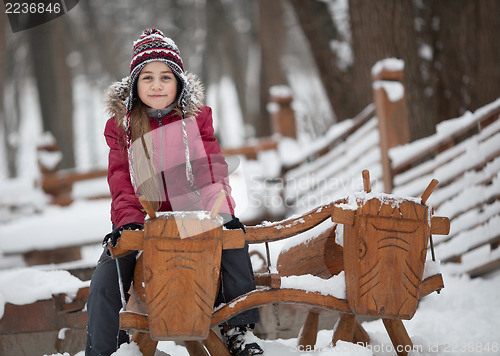 Image of Smiling girl on woody cow