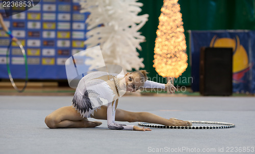 Image of Gymnast girl doing exercise with hoola hoop