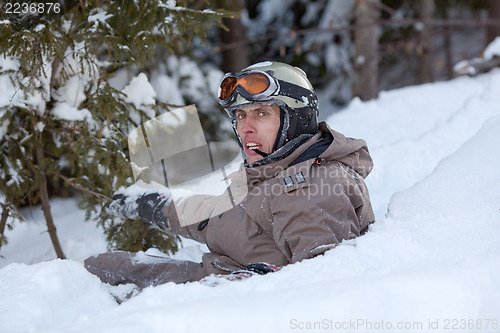 Image of Snowboarder lying on snow