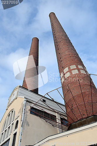 Image of industrial building and two brick chimney 