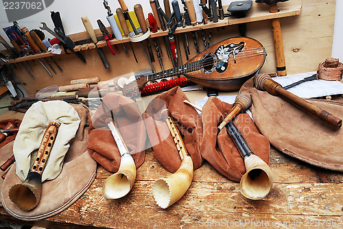 Image of workplace musical masters, bagpipes, mandolin, tools