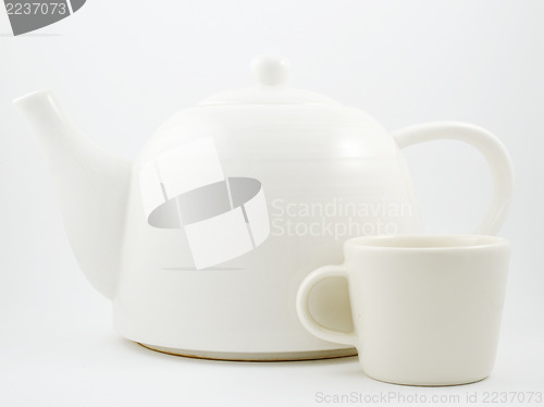 Image of stylish white porcelain teapot and cup 