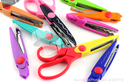 Image of Brightly colors craft scissors on a white background